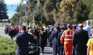 Hundreds of people marching down Sorrento's main street to the Cenotaph on the foreshore, for an ANZAC Day service.